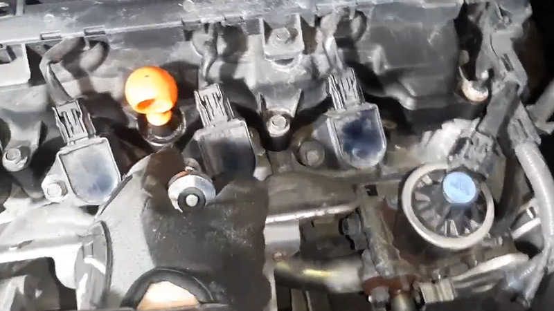 Remove the spark plugs using a wrench and screwdriver