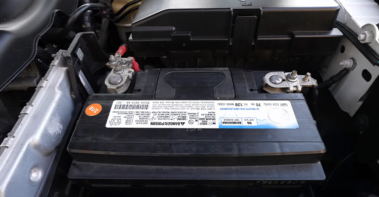 What holds a car battery in place